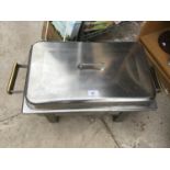 A STAINLESS STEEL OBLONG FOOD SERVING DISH WITH LID ON A STAND