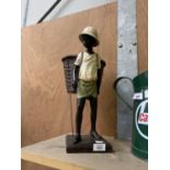 A TALL CAST MODEL OF A BOY WITH BASKET