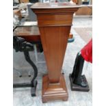 A MAHOGANY TALL HALL PLANT STAND ON STEPPED BASE