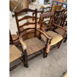 TWO LADDER BACK CARVER DINING CHAIRS WITH RUSH SEATS - ONE OAK, ONE MAHOGANY