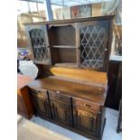 A PRIORY STYLE OAK DRESSER WITH THREE DOORS, THREE DRAWERS AND UPPER PLATE RACK WITH TWO LEAD GLAZED