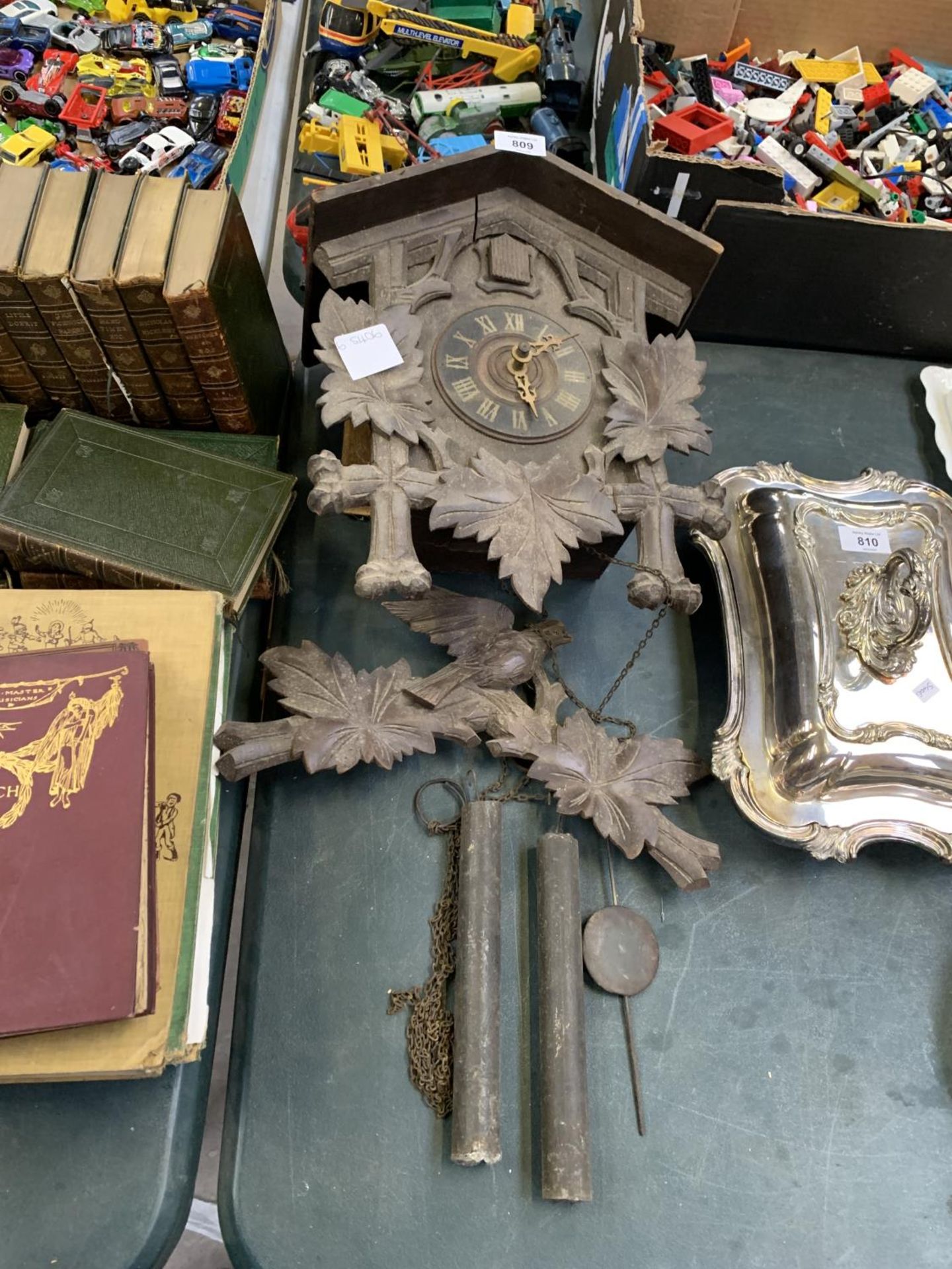 A WOODEN CARVED CUCKOO CLOCK