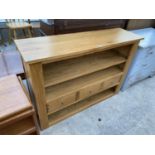 A MODERN OAK BOOKCASE WITH THREE DRAWERS