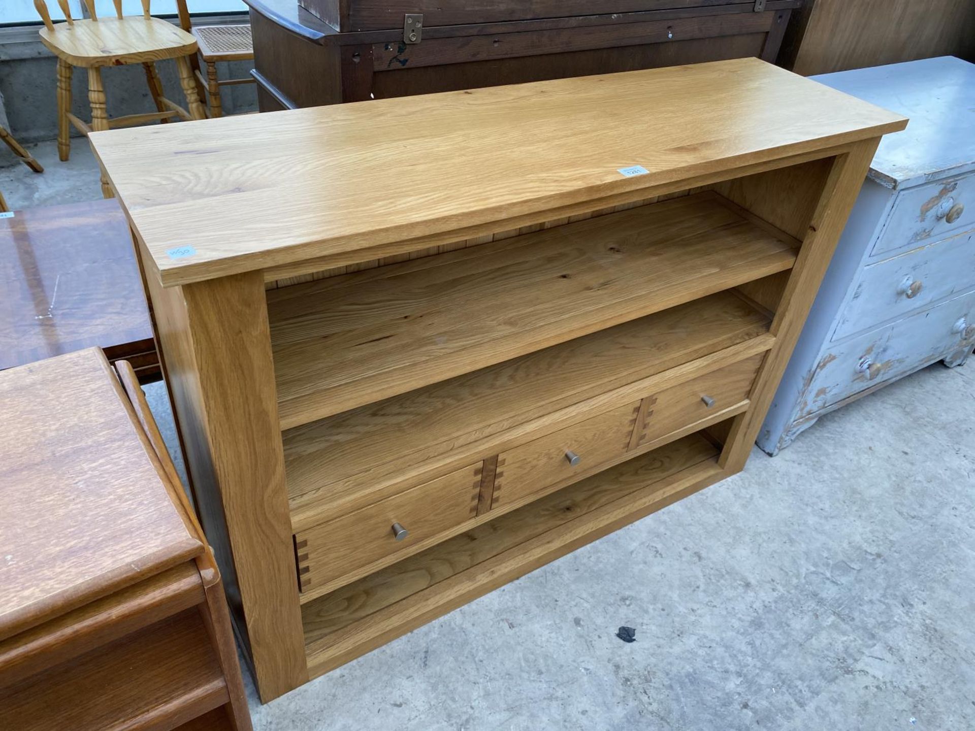 A MODERN OAK BOOKCASE WITH THREE DRAWERS