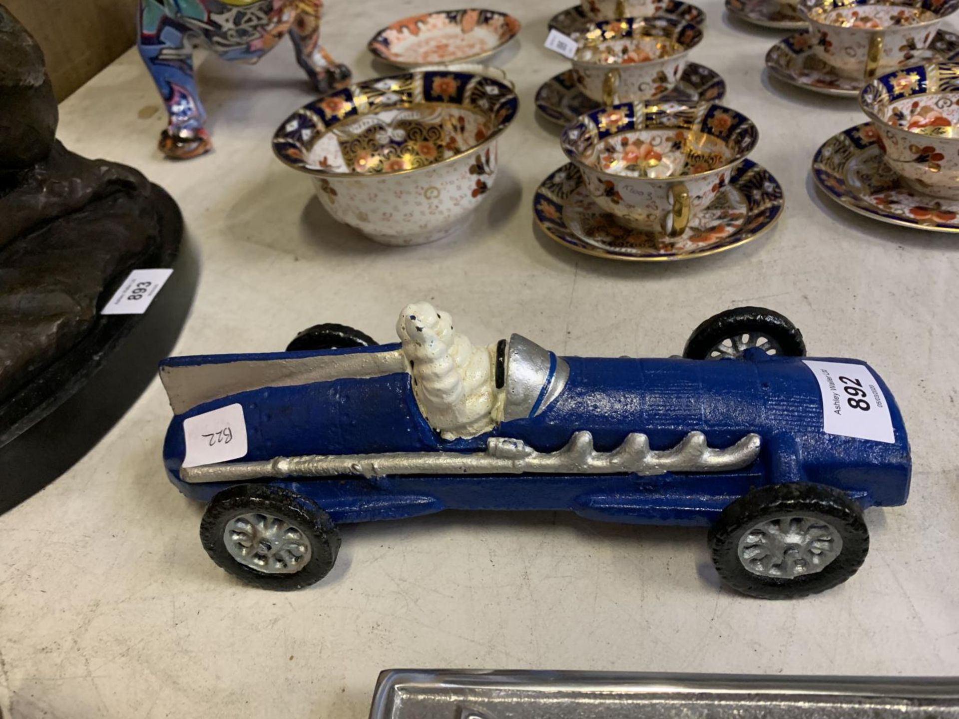 A MICHELIN MAN IN A CAST BLUE RACING CAR - Image 2 of 2