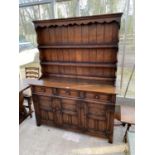 AN OLD CHARM STYLE OAK DRESSER WITH THREE DOORS, THREE DRAWERS AND UPPER PLATE RACK