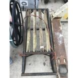 A VINTAGE METAL SLEDGE WITH WOODEN SEAT