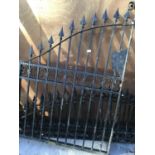 A SINGLE ORNATE WROUGHT IRON GATE AND TWO CURVED FENCE TOP PANELS