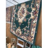 A LARGE GREEN PATTERNED RUG