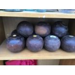 ELEVEN WOODEN BOWLING BALLS