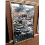 A GILT FRAMED RECTANGULAR MIRROR