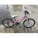 A PINK CHILDS BIKE WITH A FIVE SPEED SHIMANO GEAR SYSTEM