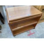 A RETRO TEAK SERVER TROLLEY WITH REVOLVING TOP