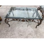 A RECTANGULAR GLASS TOP COFFEE TABLE WITH ORNATE METAL SUPPORTS