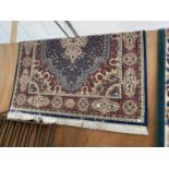 A LARGE RED PATTERNED RUG