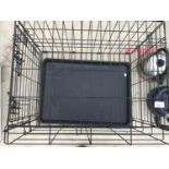 A DOG CRATE WITH TRAY