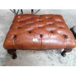 A BROWN CHESTERFIELD LEATHER BUTTON FOOT STOOL