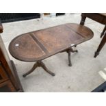 A MAHOGANY COFFEE TABLE ON TWIN PEDESTAL SUPPORTS WITH LEATHER TOP