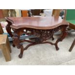 A HEAVILY CARVED MAHOGANY HALL TABLE