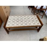 A RETRO TILE TOPPED TEAK COFFEE TABLE