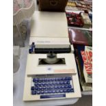 A PETITE 990 TYPE WRITER