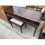 A STAG MINSTREL MAHOGANY DRESSING TABLE WITH THREE DRAWERS AND A MATCHING DRESSING STOOL