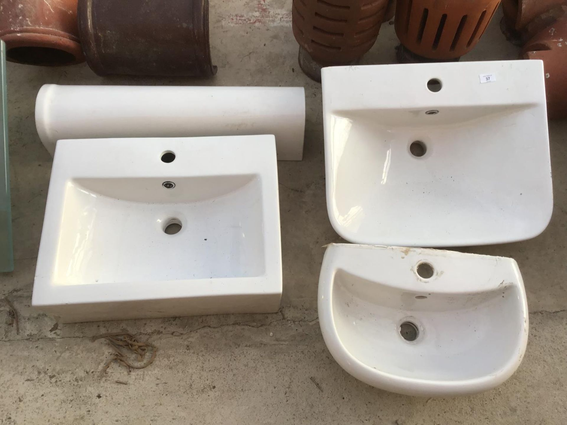 THREE WHITE WASH BASINS AND A PEDESTAL STAND