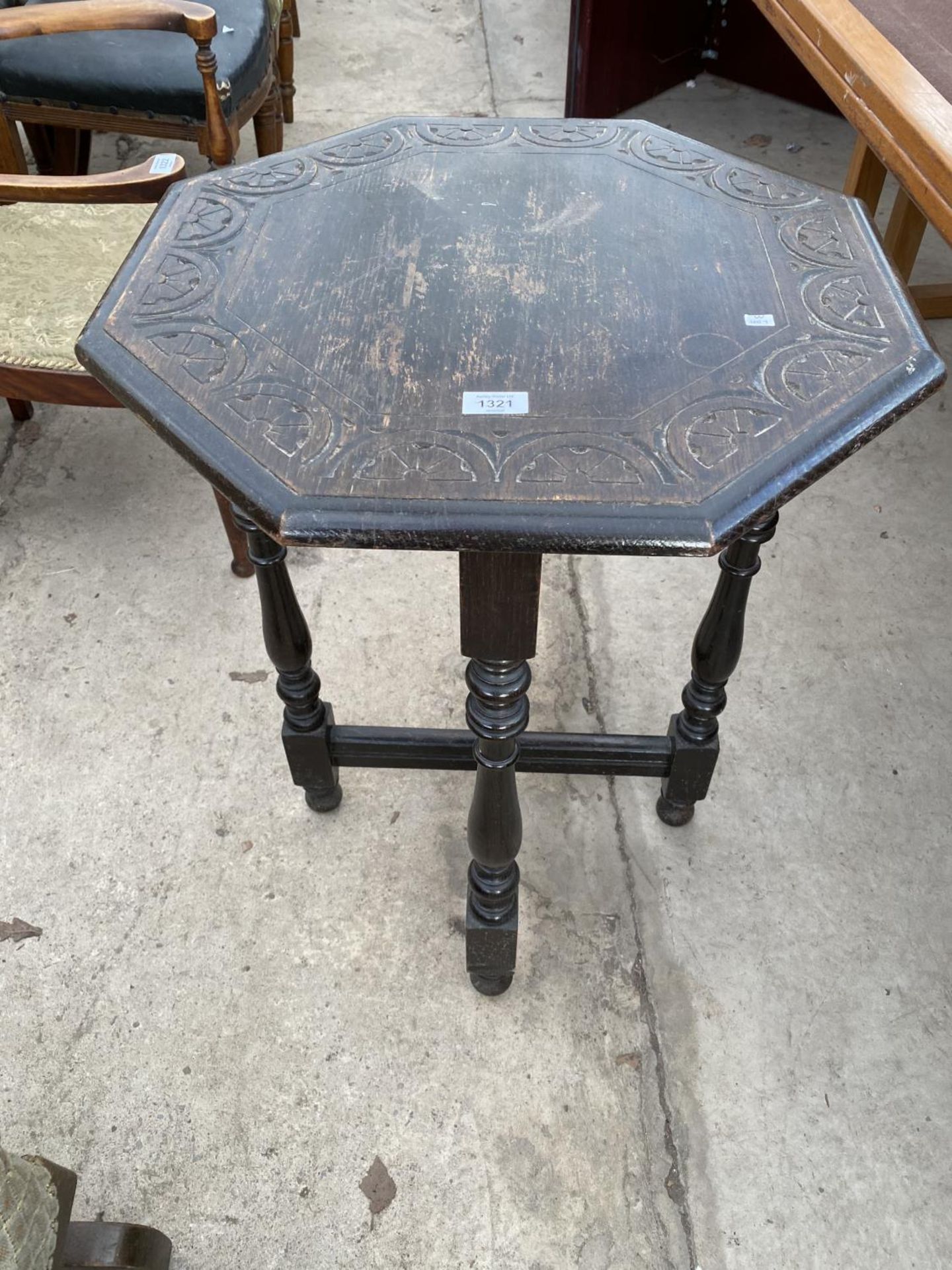 A SMALL OCTAGONAL OAK OCCASIONAL TABLE WITH CARVED TOP