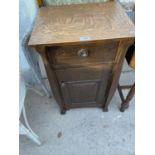 AN OAK POT CUPBOARD WITH ONE DOOR AND ONE DRAWER