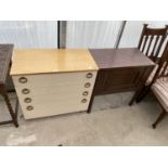 A TEAK AND CREAM CHEST OF FOUR DRAWERS AND A SMALL OAK CABINET WITH SINGLE DOOR