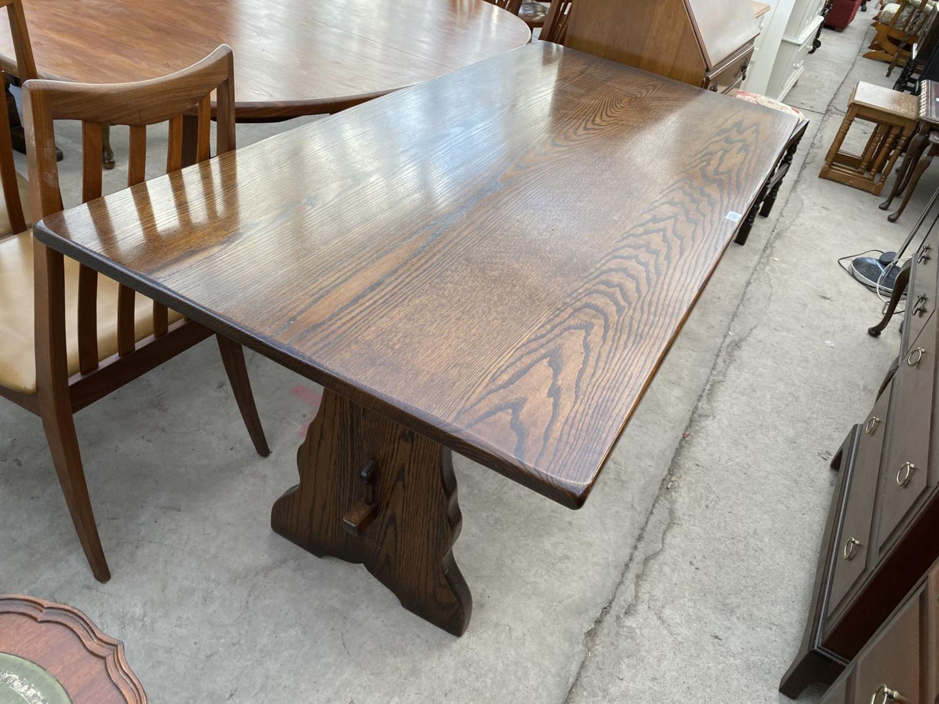 A RECTANGULAR OAK REFECTORY DINING TABLE WITH PEGGED LOWER STRETCHER RAIL