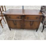 AN OAK SIDEBOARD WITH TWO DOORS AND TWO DRAWERS