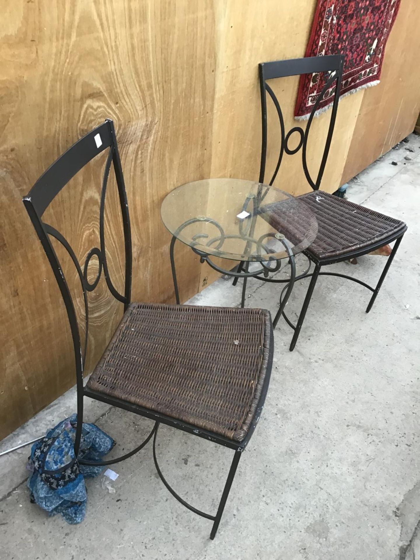 A METAL FRAMED GLASS TOPPED BISTRO STYLE TABLE (45CM) WITH A PAIR OF METAL FRAMED RATTAN SEATED - Image 2 of 2