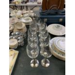 A SET OF TEN WINE GLASSES WITH METAL STEMS AND DECANTER JUG
