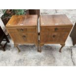 TWO WALNUT BEDSIDE CHESTS OF TWO DRAWERS ON CABRIOLE SUPPORTS