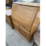 AN ERCOL GOLDEN DAWN WINDSOR BUREAU WITH FALL FRONT, TWO DOORS AND ONE DRAWER