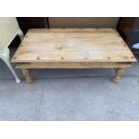 A RECTANGULAR OAK COFFEE TABLE DECORATED WITH IRON STUDS AND BANDING