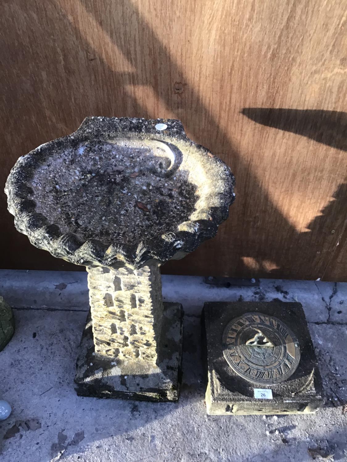 A SUNDIAL ON A CONCRETE BASE AND A CONCRETE BIRD BATH