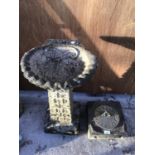 A SUNDIAL ON A CONCRETE BASE AND A CONCRETE BIRD BATH