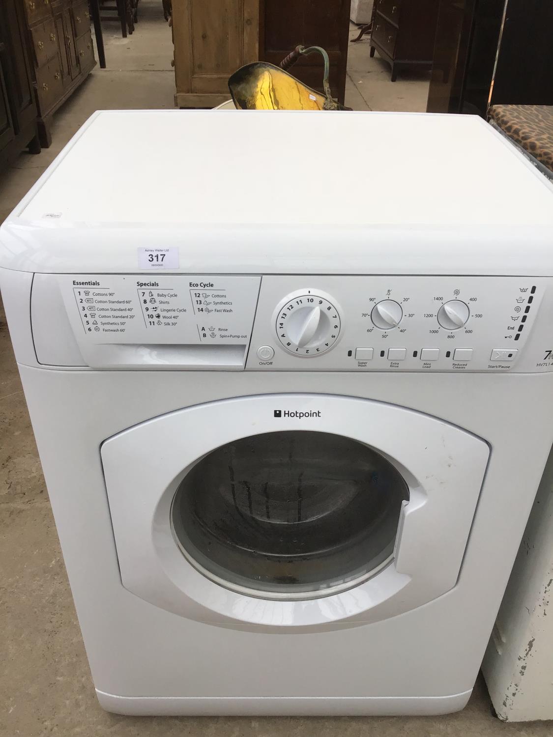 A HOTPOINT WASHING MACHINE IN NEED OF MINOR CLEAN IN WORKING ORDER