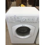 A HOTPOINT WASHING MACHINE IN NEED OF MINOR CLEAN IN WORKING ORDER