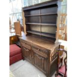 A PRIORY STYLE DRESSER WITH TWO DOORS, TWO DRAWERS AND UPPER PLATE RACK