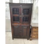 AN 18TH CENTURY OAK LARDER CUPBOARD WITH TWO LOWER DOORS AND TWO UPPER DOORS WITH TURNED STRUT