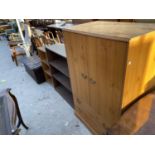 FOUR ITEMS - A LEATHERETTE OTTOMAN. TWO BOOKCASES AND A PINE EFFECT TALLBOY