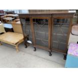 A MAHOGANY BREAK FRONT CABINET ON LION'S PAW FEET WITH THREE GLAZED PANEL DOORS