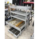 A METAL RACKING FOUR SHELF STORAGE UNIT WITH WHEELED UNDER STORAGE TRAY