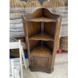 A PRIORY STYLE OAK CORNER CABINET WITH LOWER DOOR AND SHELVING