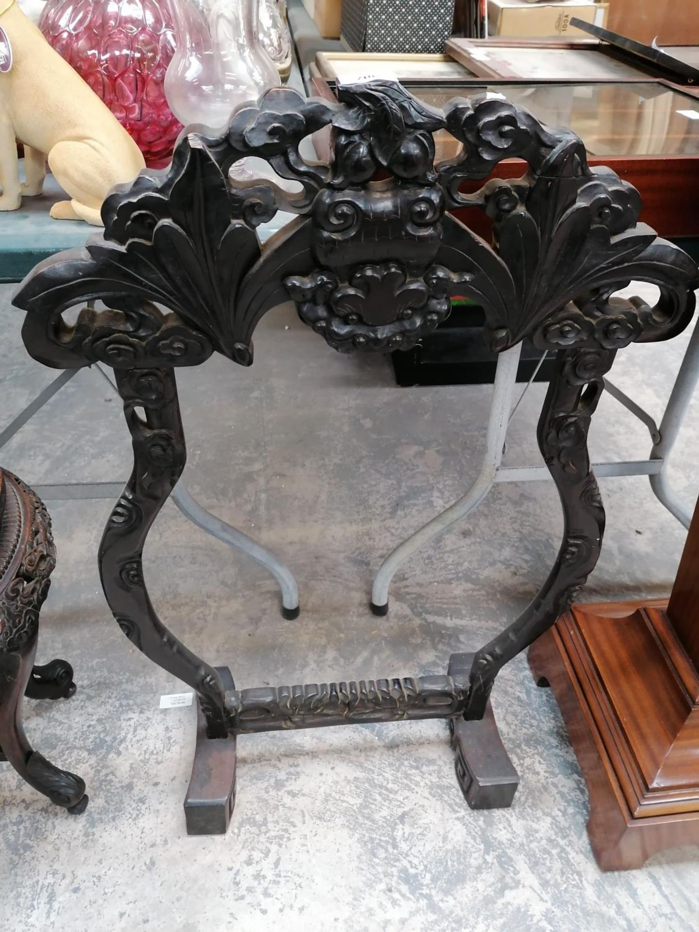 AN ORNATE DARK WOODEN GONG STAND