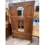 AN OAK WARDROBE WITH SINGLE BEVEL EDGE MIRRORED DOOR AND LOWER DRAWER