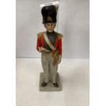 A CERAMIC HUSSAR SOLIDER FIGURE STAMPED 'REG DES' TO THE BASE